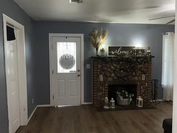 a view of a livingroom with a fireplace and window