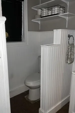a bathroom with a toilet and a shower
