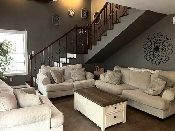 a living room with furniture and a potted plant