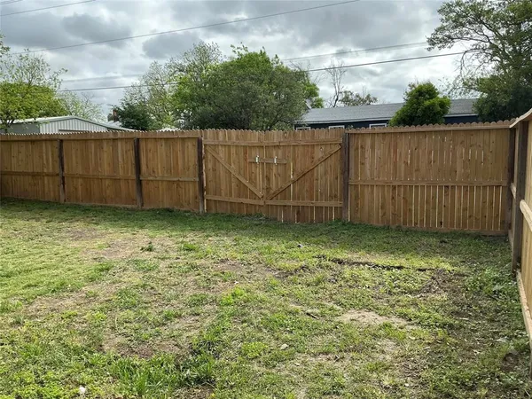 a view of a backyard with a table and chairs