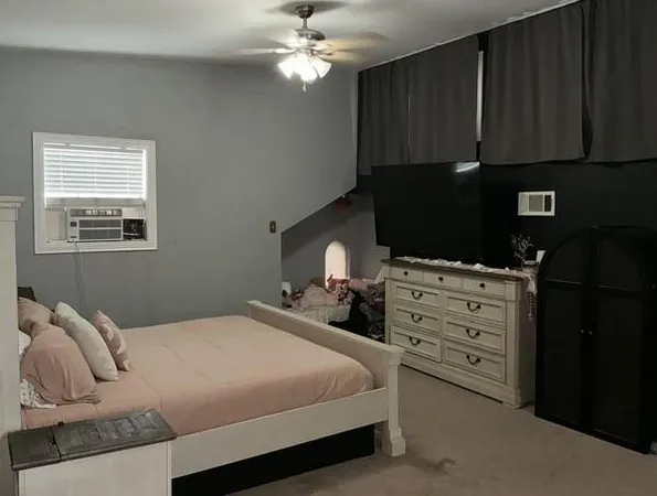 a bedroom with a bed and a television