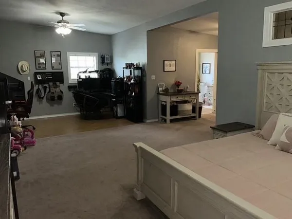 a bed room with furniture and a flat screen tv