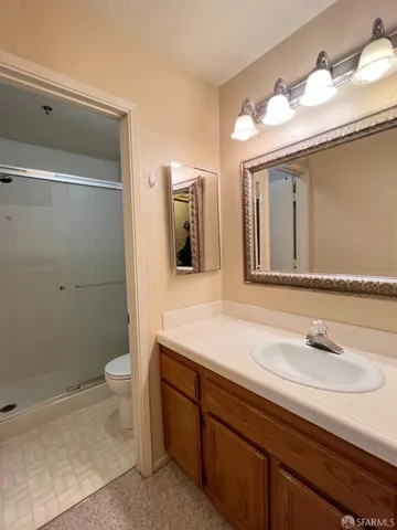 a bathroom with a sink a toilet and mirror