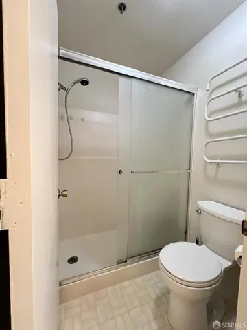 a bathroom with a shower and a toilet