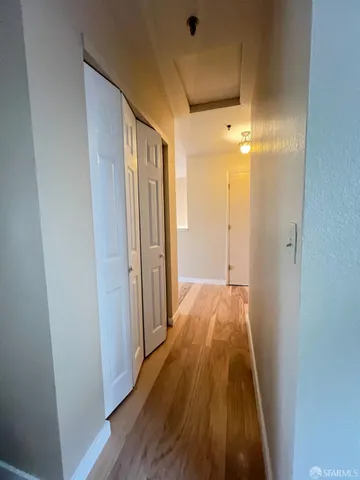 a view of hallway with wooden floor