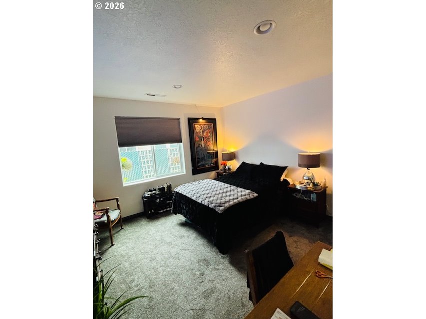 5367 Elk Ridge Drive Eugene, OR 97402 - Photo 12 of 31 a bedroom with a bed and a night stand