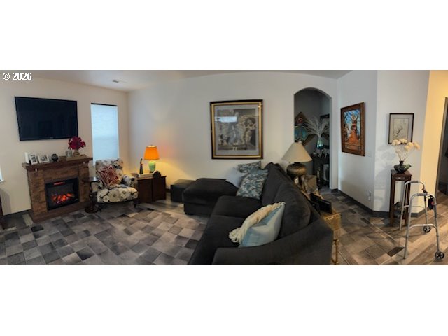 5367 Elk Ridge Drive Eugene, OR 97402 - Photo 19 of 31 a living room with furniture a flat screen tv and a fireplace