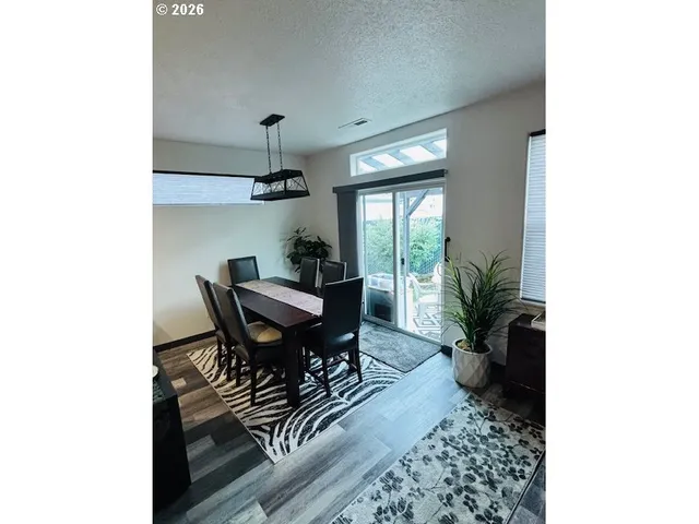 a kitchen with stainless steel appliances kitchen island granite countertop a refrigerator and a sink