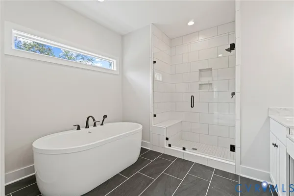 a white bath tub sitting next to a shower