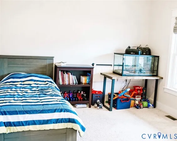 a bedroom with furniture and a book shelf