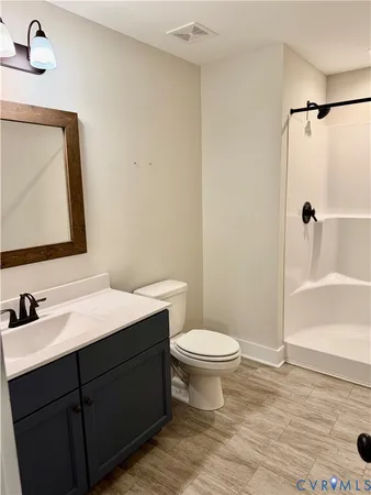 a bathroom with a sink toilet a mirror and shower