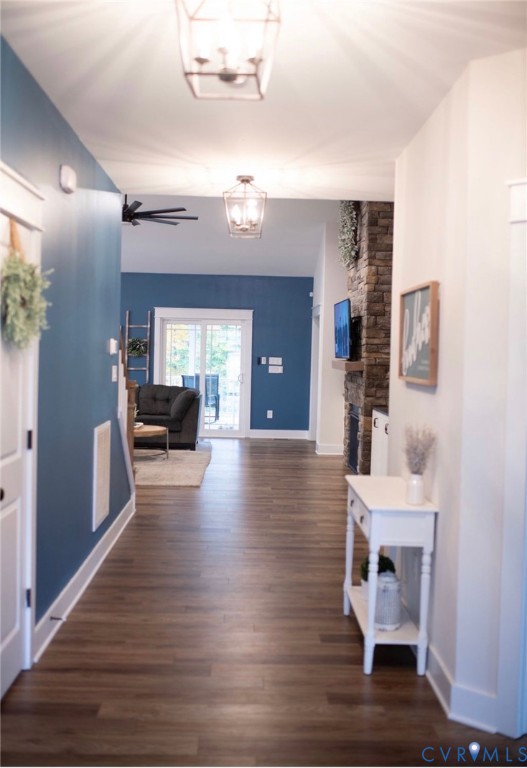 219 Eliza Lane Aylett, VA 23009 - Photo 4 of 21 Hall with dark wood-style floors and a chandelier
