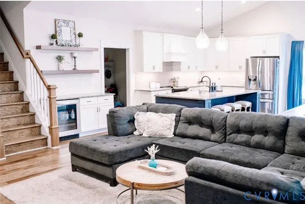 a living room with furniture kitchen view and a fireplace