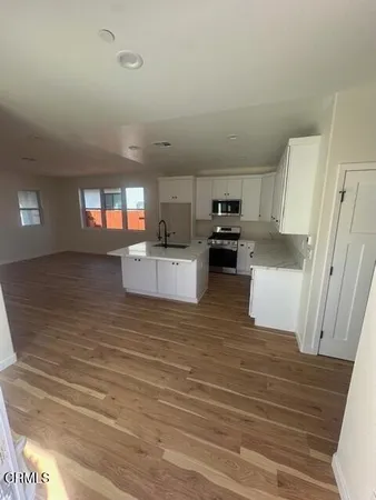 a view of a kitchen with microwave and cabinets