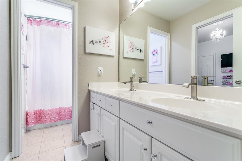1509 Blue Mesa Road Carrollton, TX 75007 - Photo 28 of 35 a bathroom with a sink vanity tub and toilet