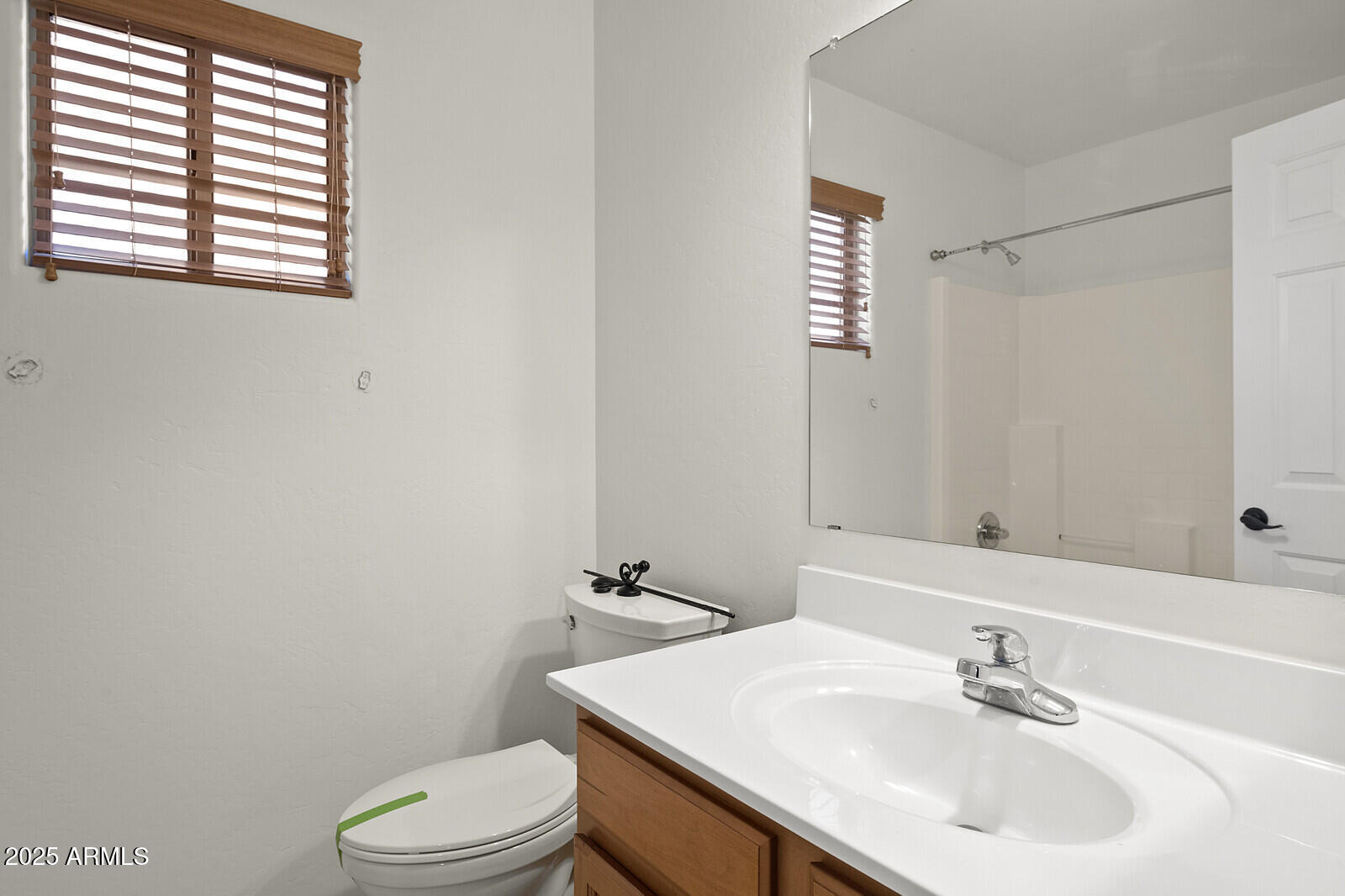 3297 East Warbler Road Gilbert, AZ 85297 - Photo 25 of 32 a bathroom with a sink a toilet and shower
