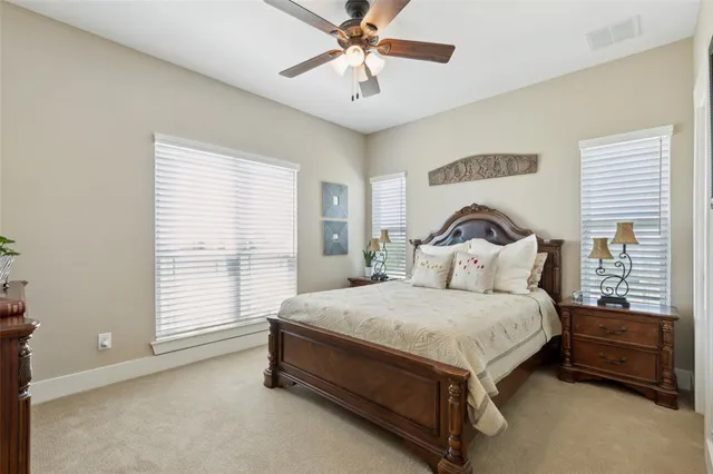 a bathroom with a sink a toilet and a large mirror