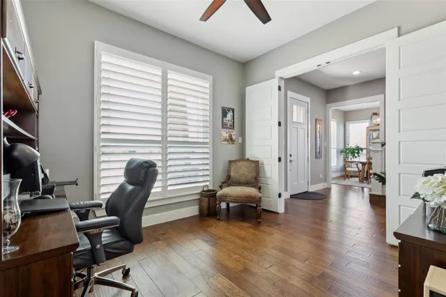 a view of a livingroom with workspace and a window