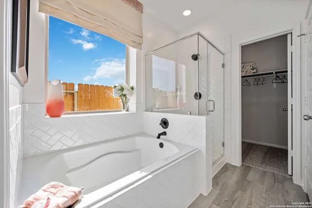a bathroom with a bathtub and a shower