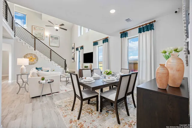 a view of a dining room with furniture and a window