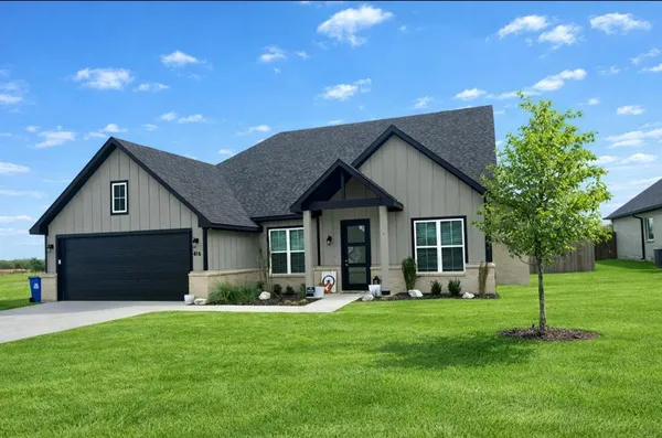 a front view of house with a garden and patio