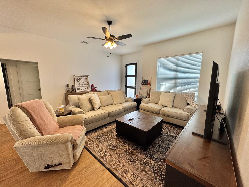 416 Austin Street Gainesville, TX 76240 - Photo 2 of 33 a living room with furniture or couch and a flat screen tv