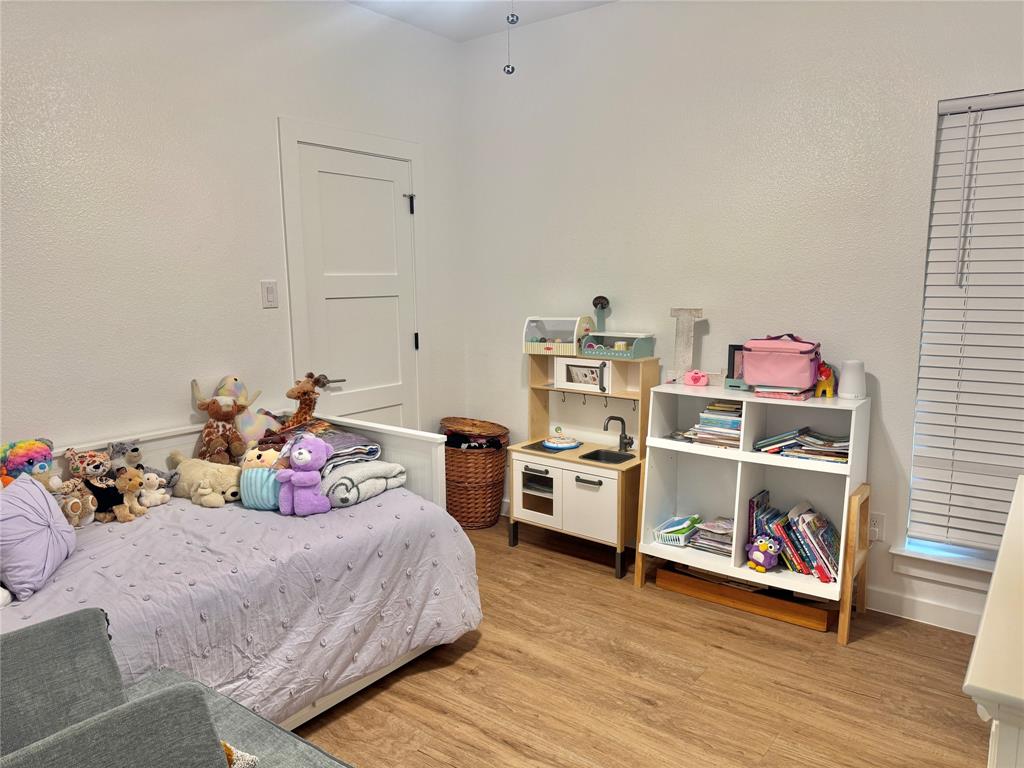 416 Austin Street Gainesville, TX 76240 - Photo 24 of 33 a bed room with a bed and a window