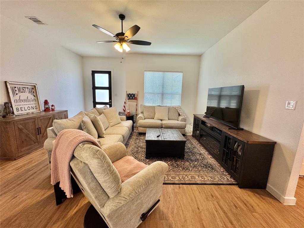 416 Austin Street Gainesville, TX 76240 - Photo 3 of 33 a living room with furniture and a flat screen tv