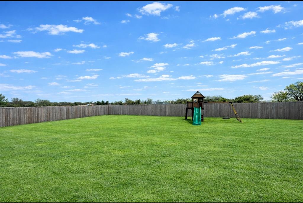 416 Austin Street Gainesville, TX 76240 - Photo 32 of 33 a view of a field of grass and a yard