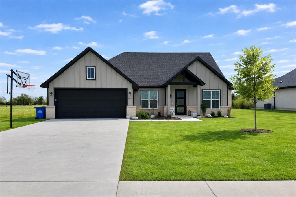 416 Austin Street Gainesville, TX 76240 - Photo 33 of 33 a front view of a house with a yard and garage