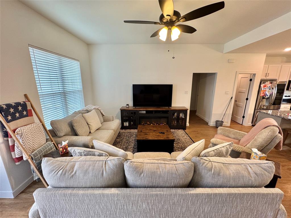 416 Austin Street Gainesville, TX 76240 - Photo 4 of 33 a living room with furniture and a flat screen tv