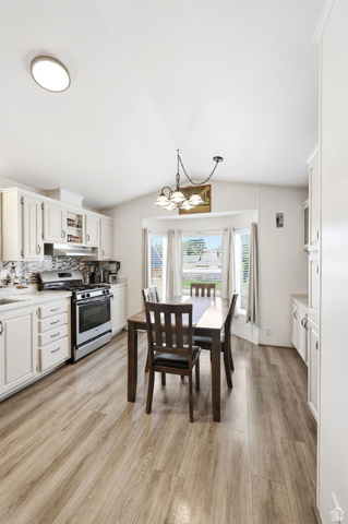 1525 South 400 East, Unit 13 Springville, UT 84663 - Photo 14 of 32 Kitchen and dining area featuring wood-finish flooring, white cabinetry, stainless steel range, and a tiled backsplash