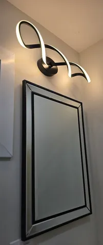 an empty room with white wall and an entryway