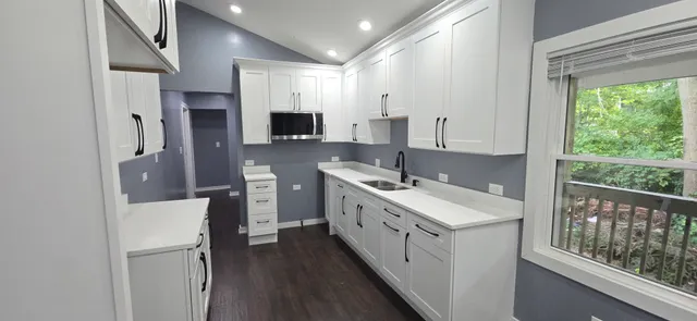 a kitchen with sink and window