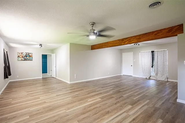 wooden floor in an empty room with a window