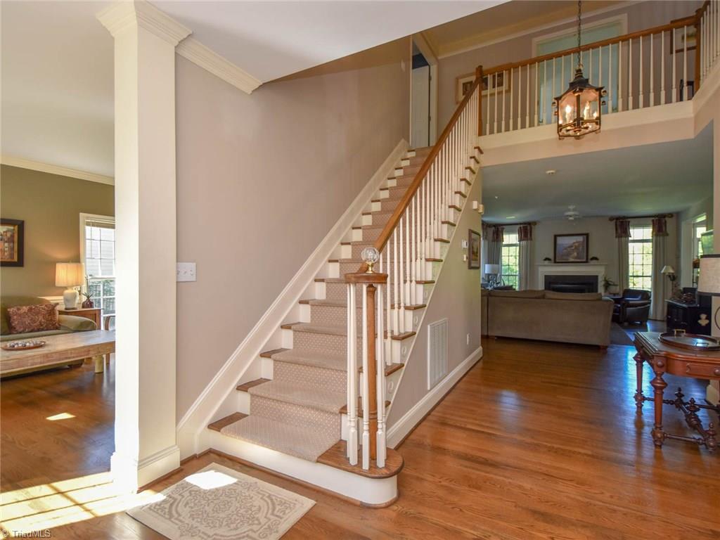 3817 Pinetop Road Greensboro, NC 27410 - Photo 2 of 29 Large two-story foyer opens to living room to left, dining room to right, and den straight ahead. Beautiful wood floors throughout main level.