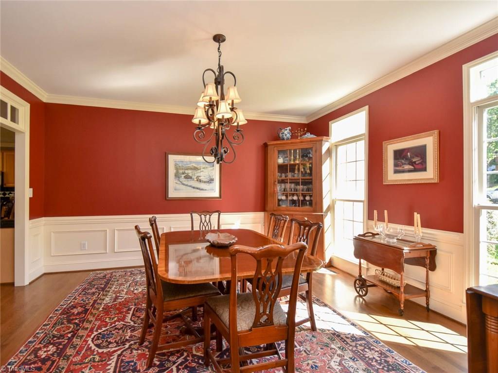 3817 Pinetop Road Greensboro, NC 27410 - Photo 7 of 29 Dining room off foyer features wainscoting and crown molding, large doorways.