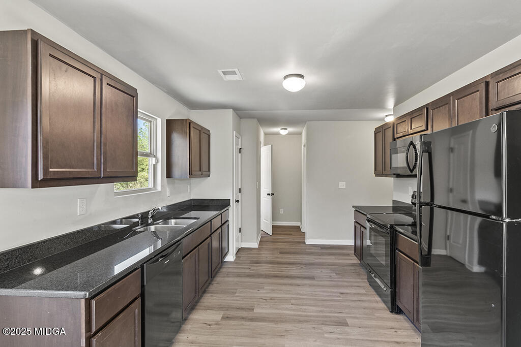 306 Mill Meadow Road Macon, GA 31216 - Photo 11 of 29 a kitchen with stainless steel appliances granite countertop a stove and a refrigerator