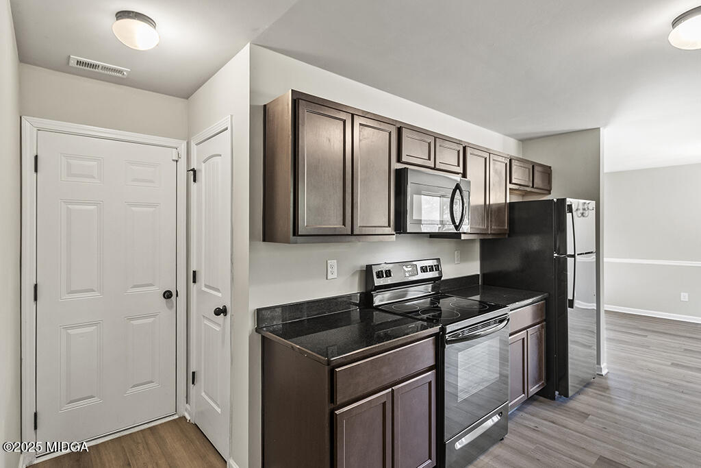 306 Mill Meadow Road Macon, GA 31216 - Photo 13 of 29 a kitchen with stainless steel appliances granite countertop a refrigerator and a stove