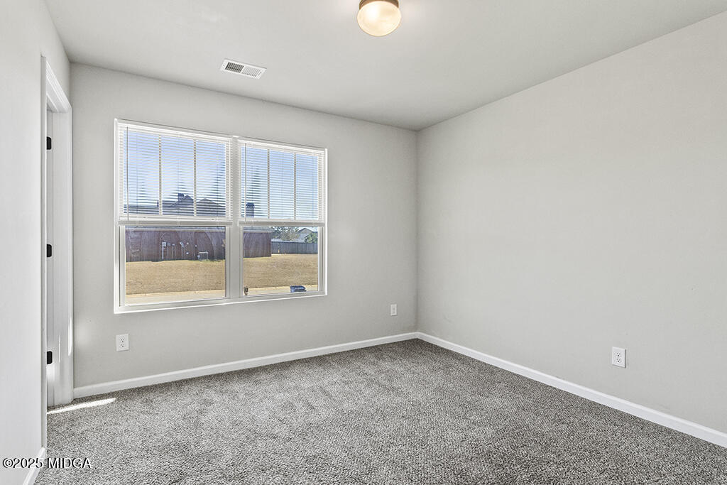 306 Mill Meadow Road Macon, GA 31216 - Photo 22 of 29 an empty room with a window