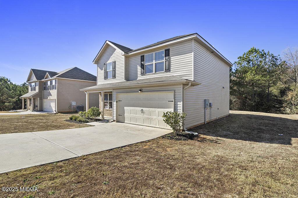 306 Mill Meadow Road Macon, GA 31216 - Photo 3 of 29 a front view of a house with a yard and garage