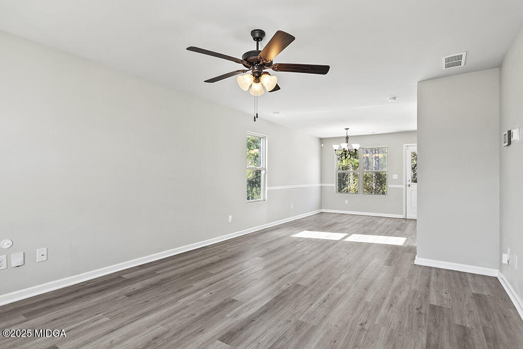 306 Mill Meadow Road Macon, GA 31216 - Photo 7 of 29 wooden floor in an empty room with a window