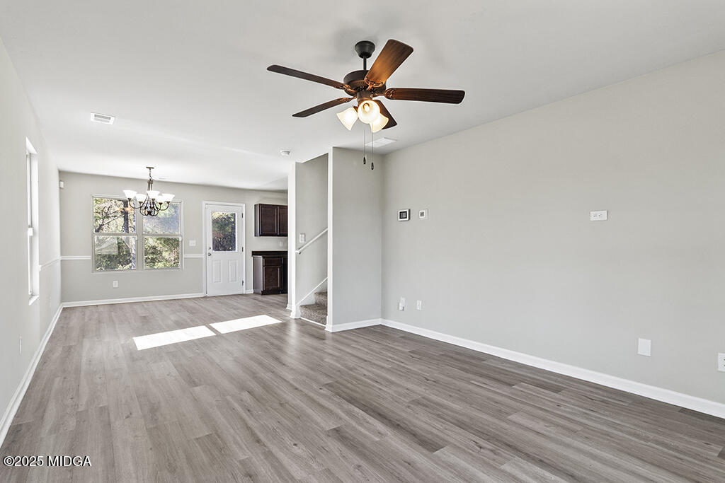 306 Mill Meadow Road Macon, GA 31216 - Photo 9 of 29 a view of an empty room with wooden floor and a window