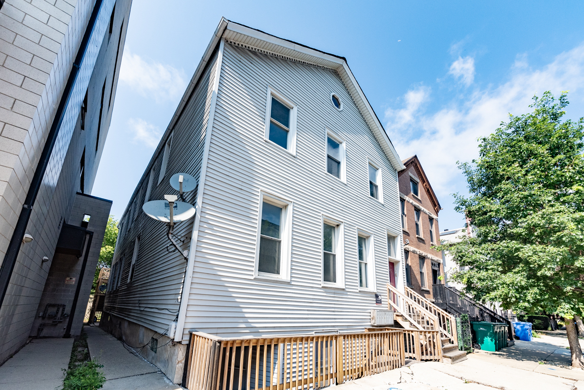 1022 West Fry Street, Unit 2F Chicago, IL 60642 - Photo 1 of 15 a front view of a house with a yard