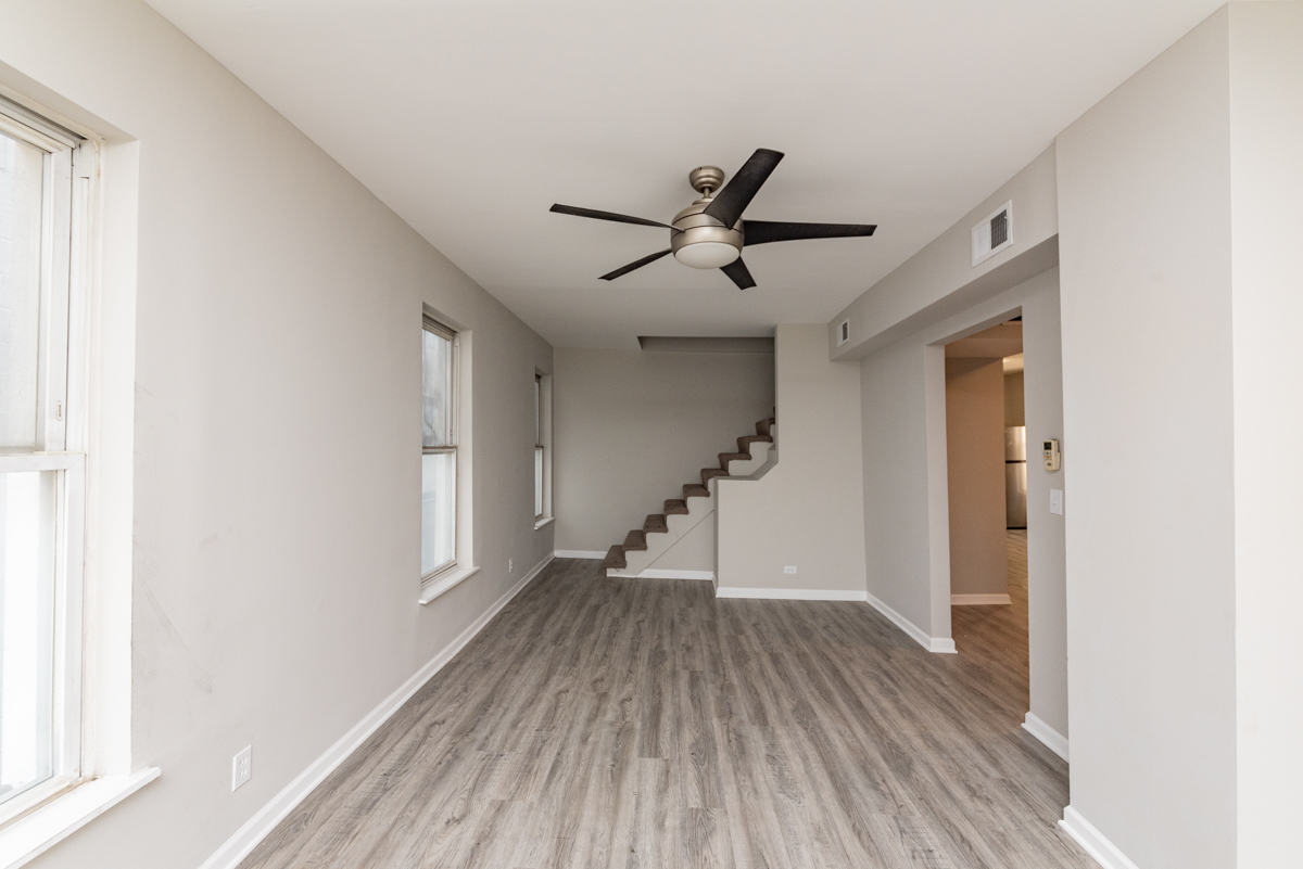 1022 West Fry Street, Unit 2F Chicago, IL 60642 - Photo 3 of 15 a view of empty room with wooden floor and fan