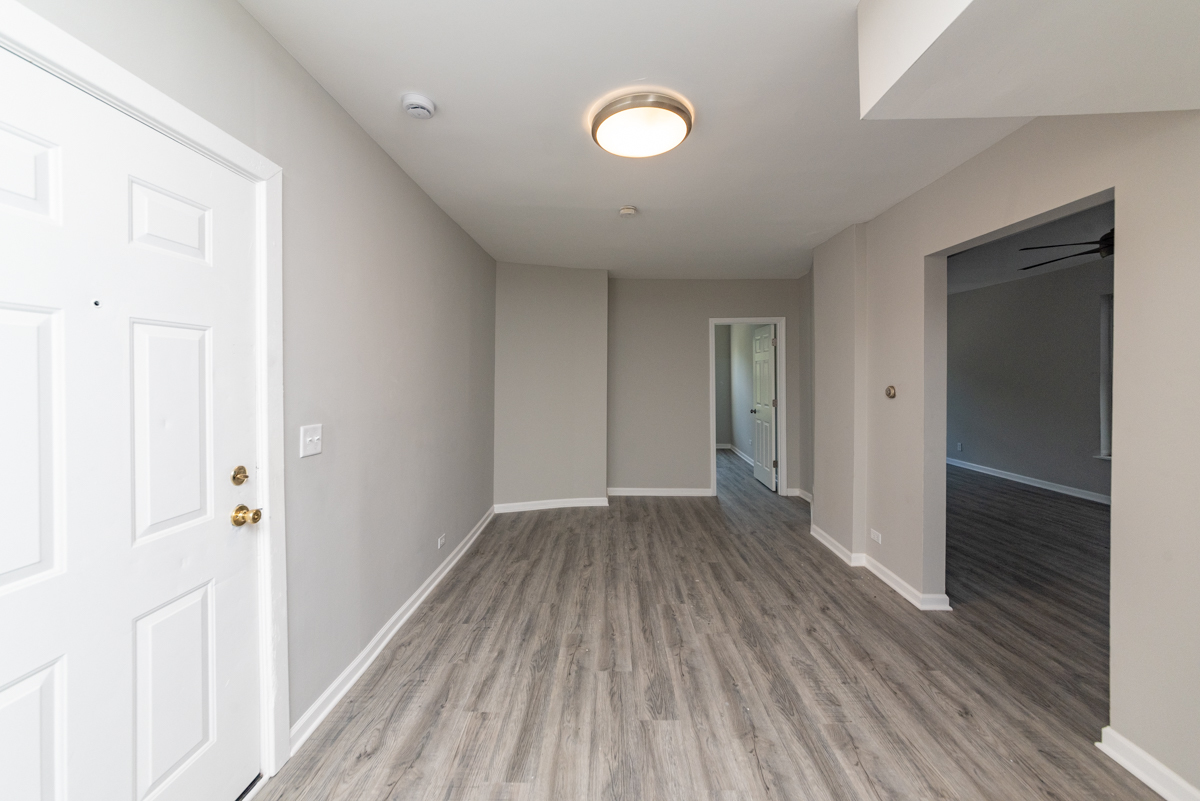 1022 West Fry Street, Unit 2F Chicago, IL 60642 - Photo 4 of 15 a view of a hallway with wooden floor