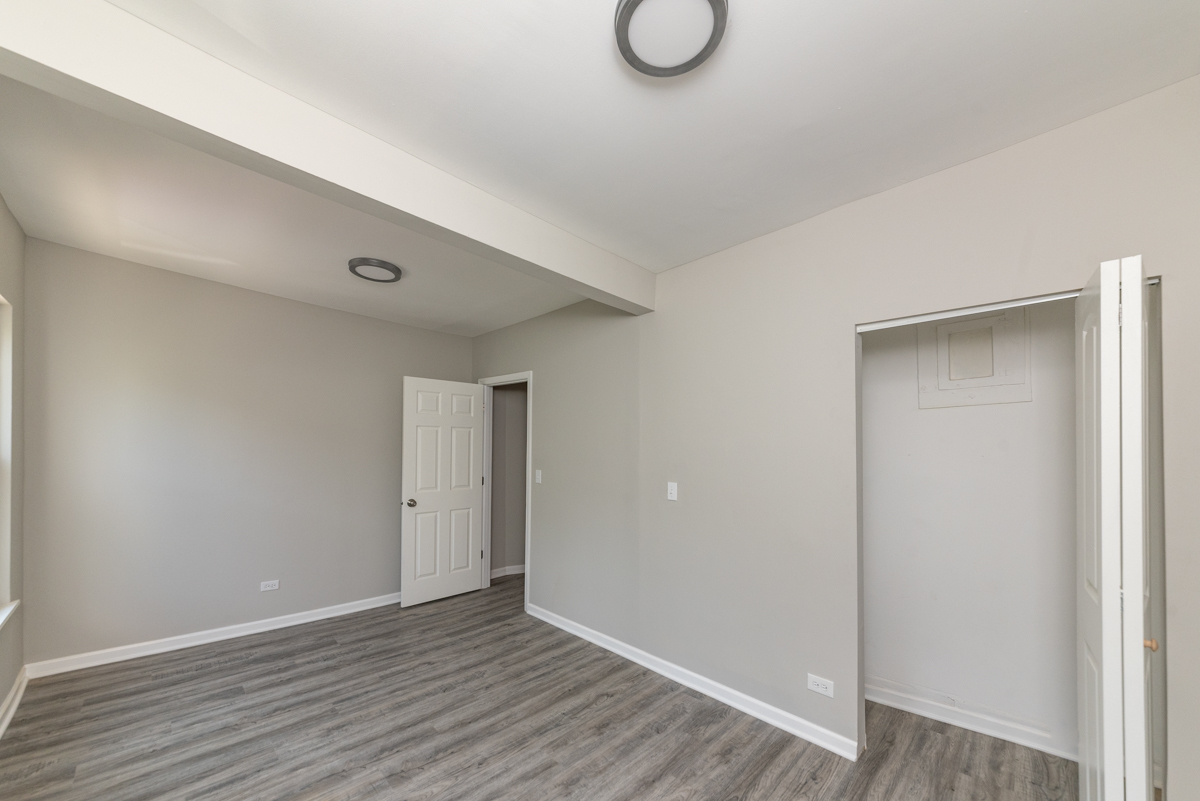 1022 West Fry Street, Unit 2F Chicago, IL 60642 - Photo 7 of 15 a view of an empty room with wooden floor and closet
