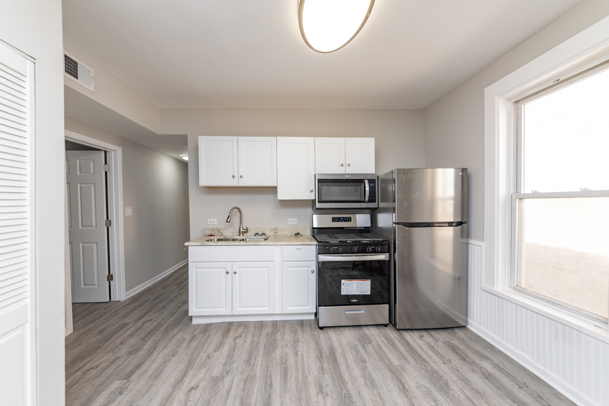 1022 West Fry Street, Unit 2F Chicago, IL 60642 - Photo 8 of 15 a kitchen with stainless steel appliances a stove a sink and a refrigerator