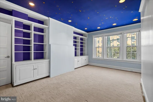 an empty room with windows and closet