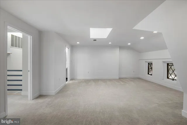 a view of room with window and a ceiling fan
